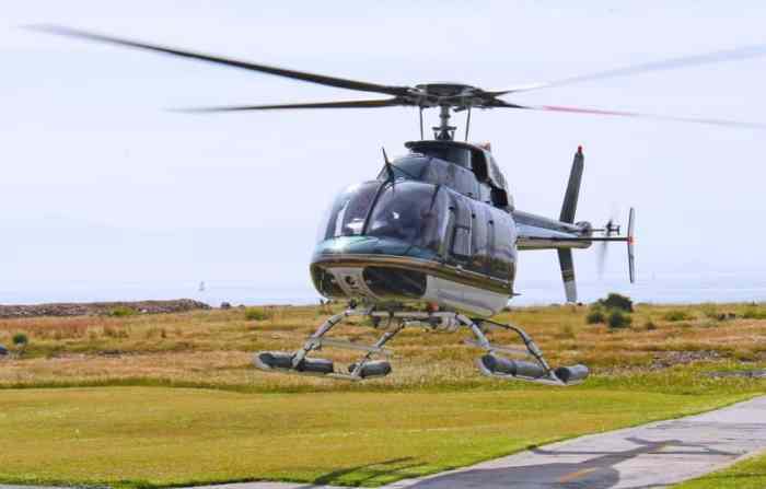 A pilot in a helicopter spots a landing pad below